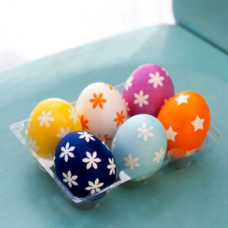 Use various punches to punch out designs from masking tape. Place these around the egg and apply a coat of spray paint. Remove the stickers once the paint is dry.