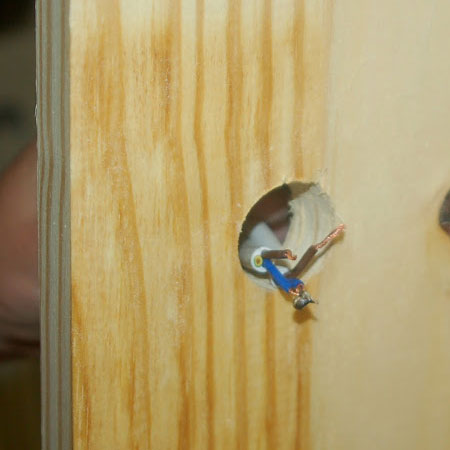 push electrical wires through drilled hole