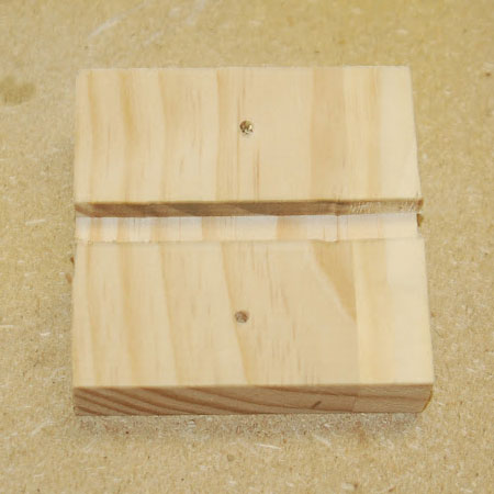 cut two slots in small block of wood