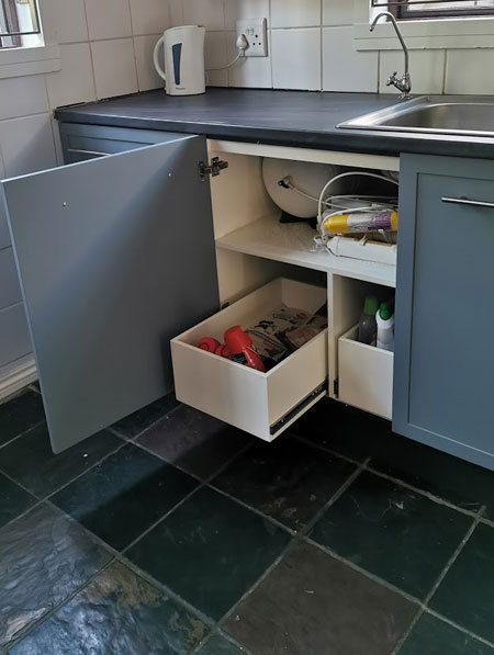 kitchen cupboards underneath sink with storage