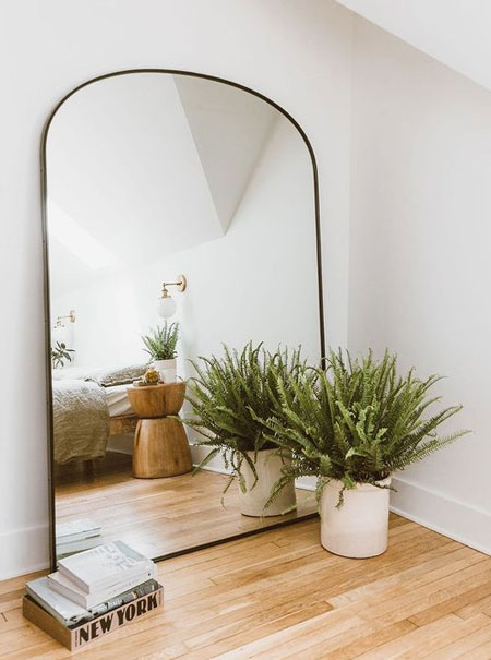 mirror makes bedroom feel larger