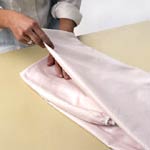 Keep wrinkles to a minimum by pulling sheets out of the tumble dryer and folding them while they're still warm
