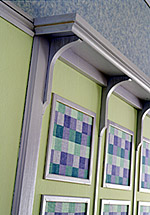 Cut squares of wallpaper or fabric, then glue them to wall