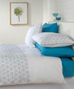 Turquoise and white create a tranquil setting in this bedroom