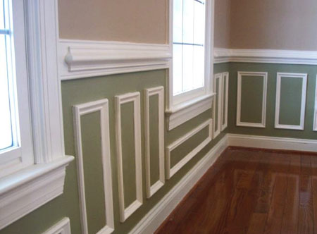 applying moulding and trim painted in a white to walls