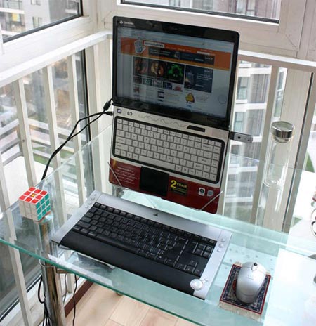 Hip, hanging laptop stand made with a coat hanger
