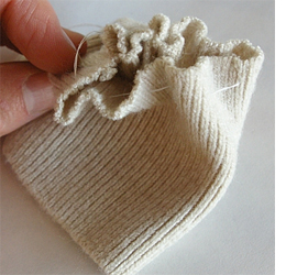 Here's how to upcycle a sweater or jersey into cushion cover
