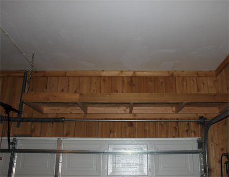 Install shelves above garage door