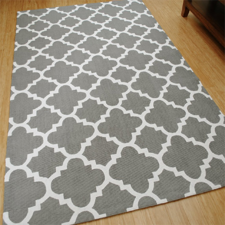 Use acrylic paint to stencil design on a rug or mat
