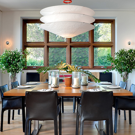 dining table dressed with a few select decor accessories and foliage