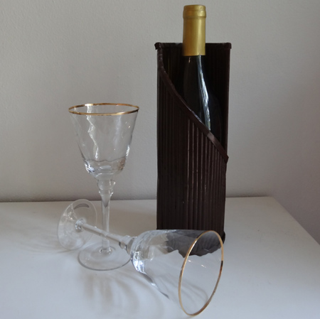 Rolled newspaper wine bottle holder 