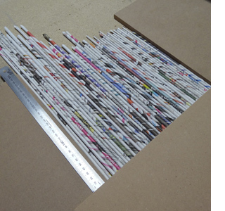 Rolled newspaper wine bottle holder 