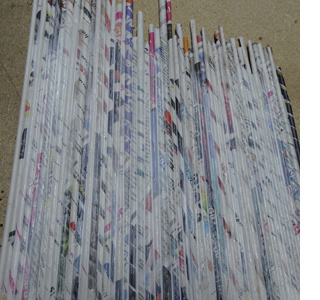Rolled newspaper wine bottle holder 