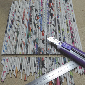 Rolled newspaper wine bottle holder 