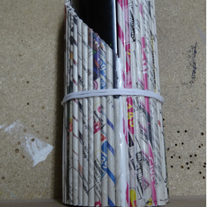 Rolled newspaper wine bottle holder 
