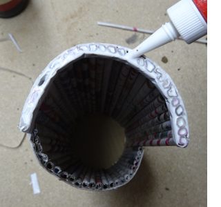 Rolled newspaper wine bottle holder 