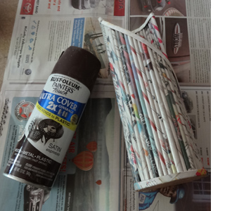 Rolled newspaper wine bottle holder 