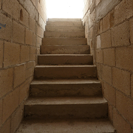 clad concrete staircase with wood risers and steps