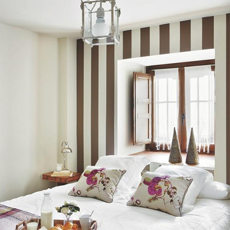 how to decorate warm comfortable cosy bedroom striped wall