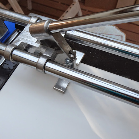 diy tiling kitchen placing white tiles on wall cut with tile cutter