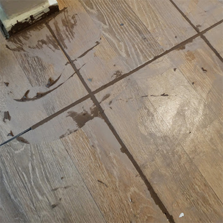 grout floor tiles with a tal squeegee