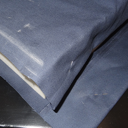 Making upholstered cushions for outdoor sofa mark fabric with chalk