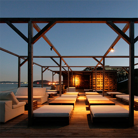 Entertainment deck and beach bar constructed of reclaimed pallets