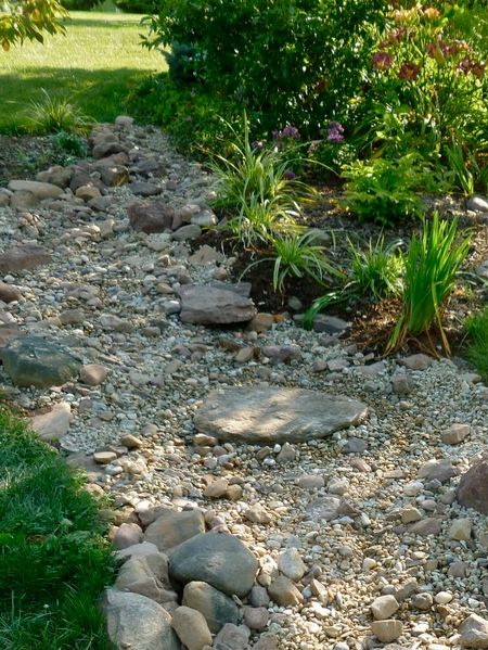 Pebble and rock river bed for garden drainage