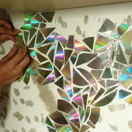 Recycle CD's into a gorgeous shimmering kitchen backsplash glue to wall