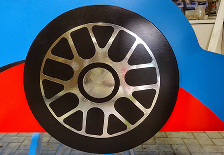 Allow a day or so for the paint to dry completely before carefully applying your choice of stickers to finish the race car bed.