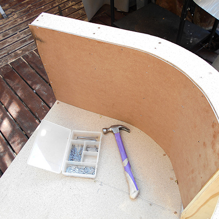 These sections were fastened in place to the top, frame and bottom sections using wood glue and panel pins. 