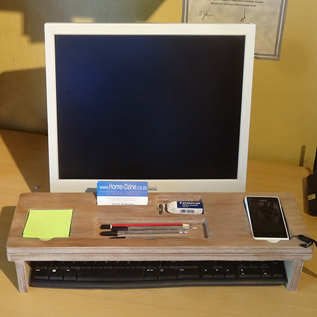 storage holder that fits over a keypad for pens and pencils, notepad and cellphone