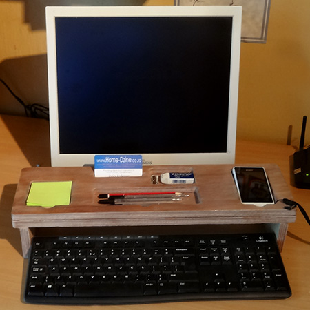 storage holder that fits over a keypad for pens and pencils, notepad and cellphone