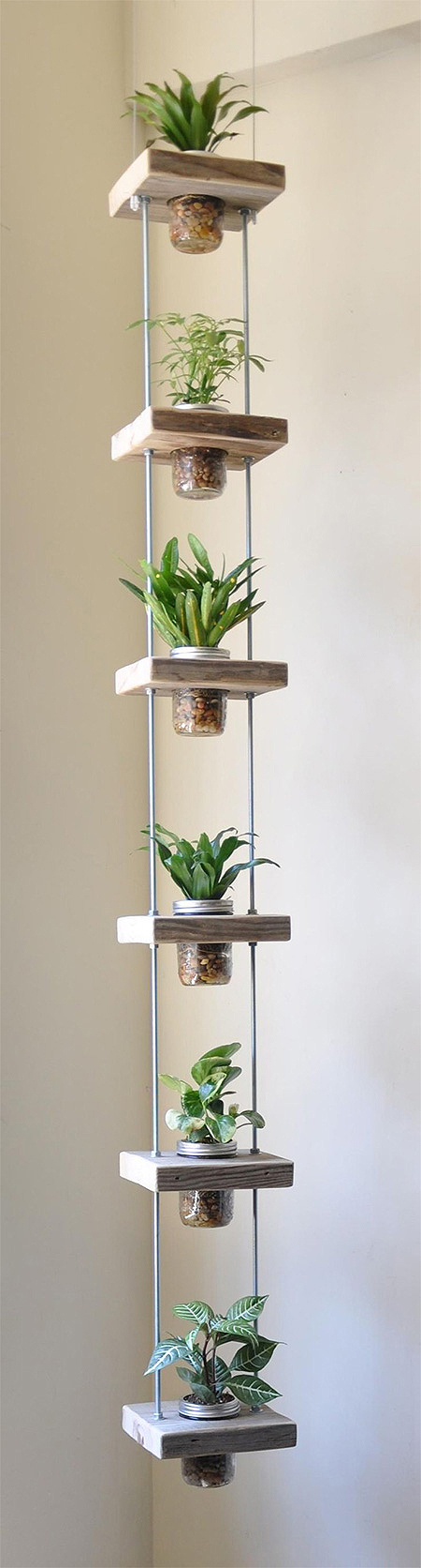 Make this vertical planter using blocks of reclaimed wood, threaded rods and nuts, and some recycled food jars or mason jars.