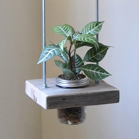 Make this vertical planter using blocks of reclaimed wood, threaded rods and nuts, and some recycled food jars or mason jars.