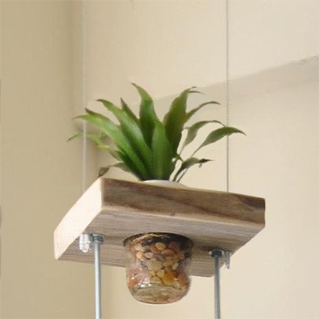 Make this vertical planter using blocks of reclaimed wood, threaded rods and nuts, and some recycled food jars or mason jars.