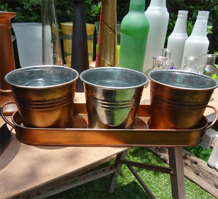 Rust-Oleum Universal Aged Copper was used on these inexpensive galvanised zinc flower pots to give them a vintage finish