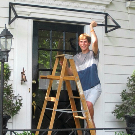 The awning frame is designed to that the top cross section and side frame are flush for mounting to the wall above and at the side of the door.