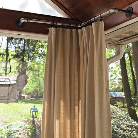 Galvanised pipe offers an easy way to mount curtains on a patio or deck for privacy