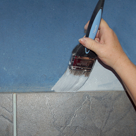 Use a paintbrush to cut in around all the edges