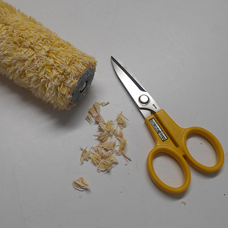 Cut off any scruffy edges on a paint roller for a clean paint edge