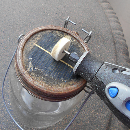 1. To clean the top solar panel I dipped the polishing wheel in a solution of dishwashing liquid and warm water and set the Dremel MultiTool on slow to clean away all the built-up grime. Repeat as often as necessary and then wipe dry.