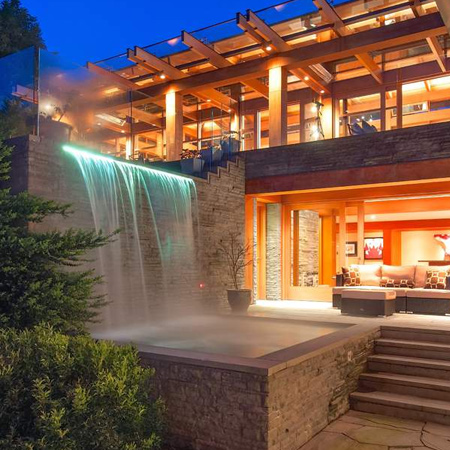 The landscaped gardens that surround the property reflect the style of the house and incorporate Japanese elements. Minimal planting, abundant water features and a Koi pond offer a calm, tranquil setting.
