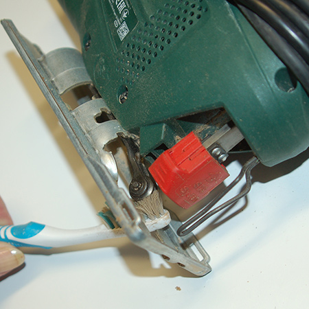 An old toothbrush is perfect for getting into tight areas on your tools to clean away built up debris. You can also use an old, stiff artists paintbrush for smaller tools, or a stiff bristle paintbrush for larger power tools. 