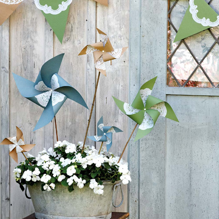 Paper pinwheels never go out of fashion and it's easy to make your own. Before assembly, glue cut out doilies onto the coloured or patterned paper. 