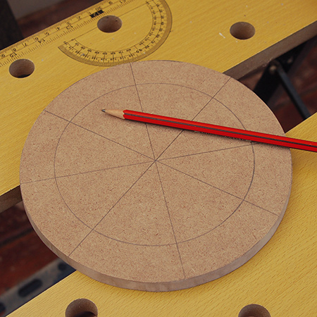 6. Use a pencil and ruler to divide each circular board into eight segments.&nbsp;