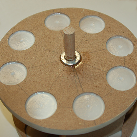 13. Once again, epoxy glue was applied around the centre hole and dowel, and a washer and more epoxy glue added. 