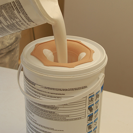 Place the lid firmly on the empty paint container and pour watered down paint into this. This method is also a great way to remove lumps from paint.