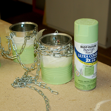 3. The bottom of each can was sprayed with Rust-Oleum 2X in satin green apple. I did this after attaching the chains to prevent scratching the paint.&nbsp;