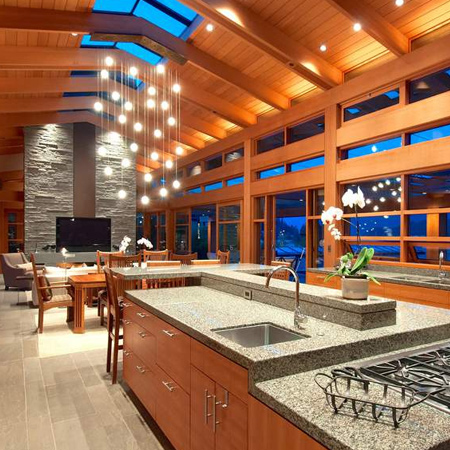 The kitchen features solid fir windows and doors and is fitted with custom cabinetry and modern appliances. The large centre island dominates the space and also doubles as a breakfast bar.